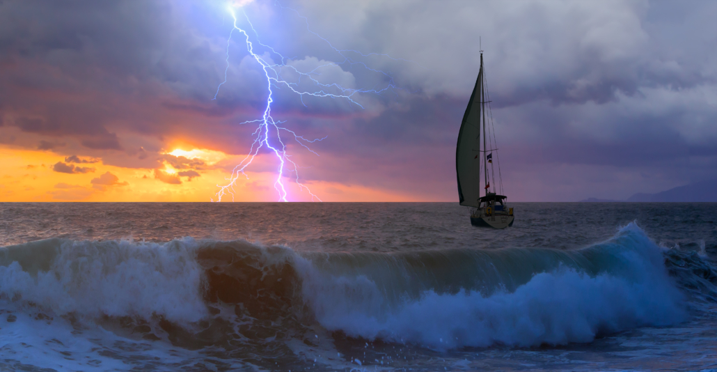 Image shows a sailboat in stormy weather.