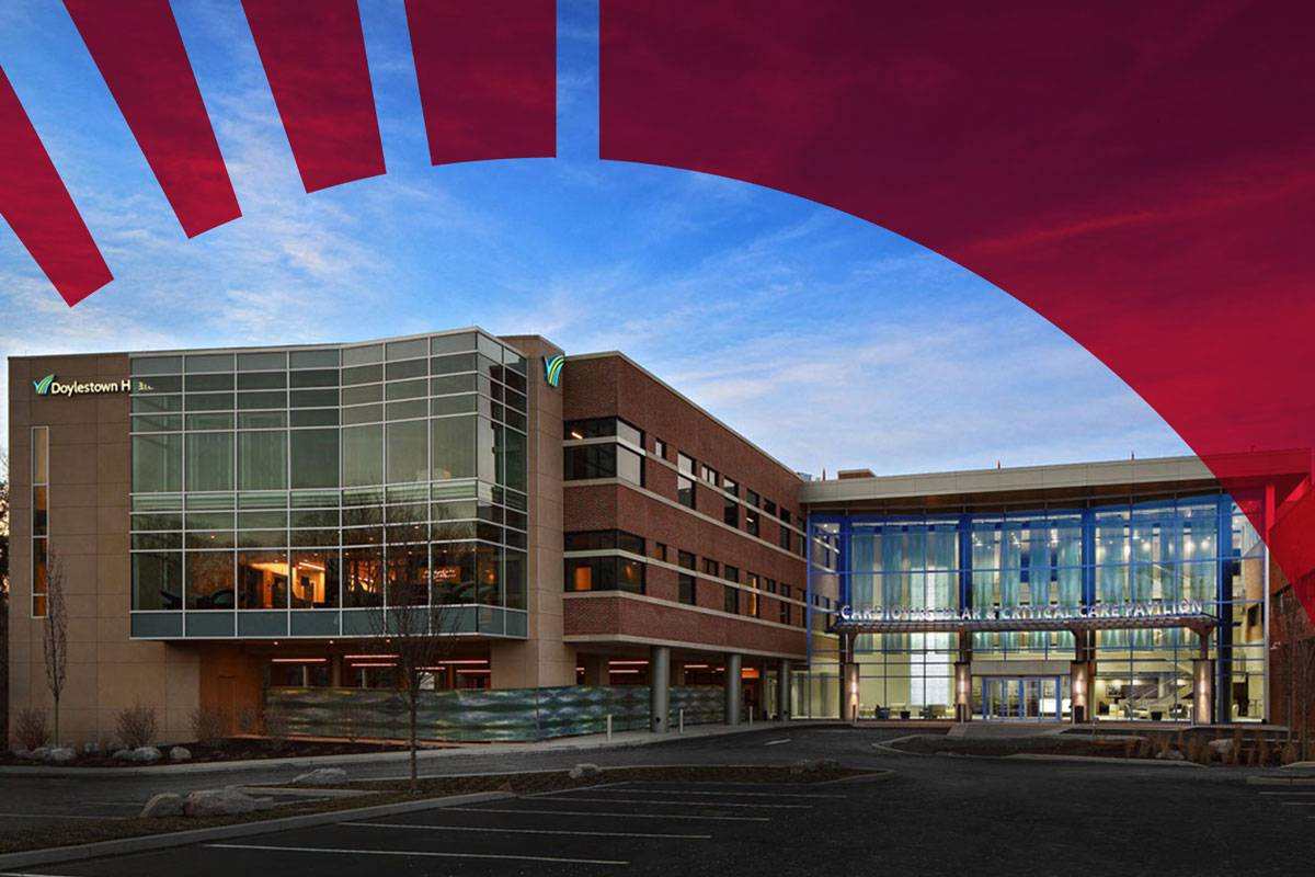 d1-min-min Exterior of Doylestown Health's Cardiovascular and Critical Care Pavilion at dusk.